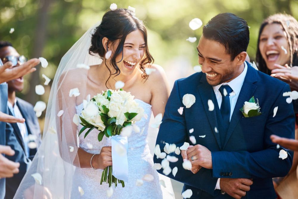 Wedding Couple with confetti and guests